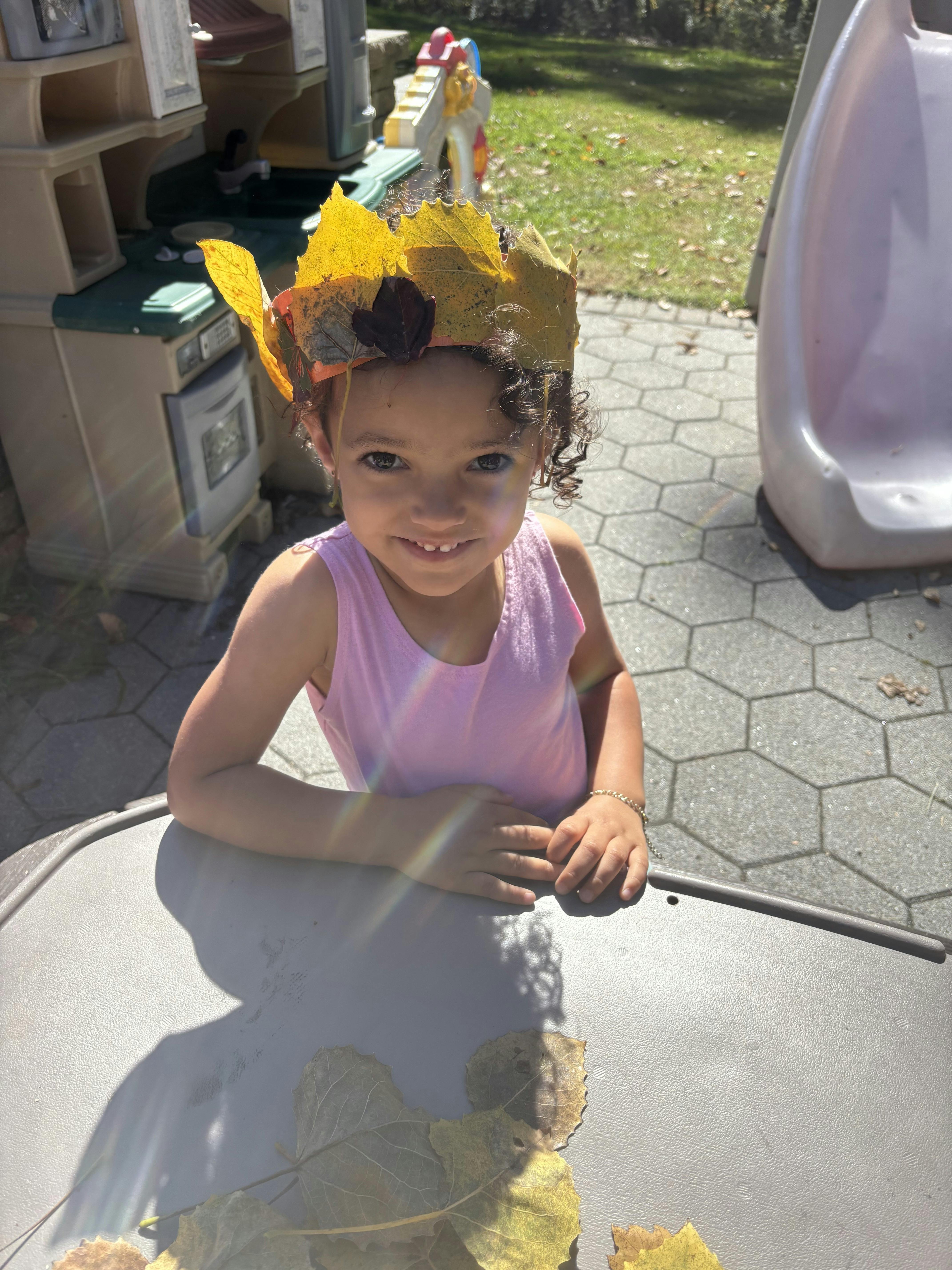 Child wearing a leaf crown