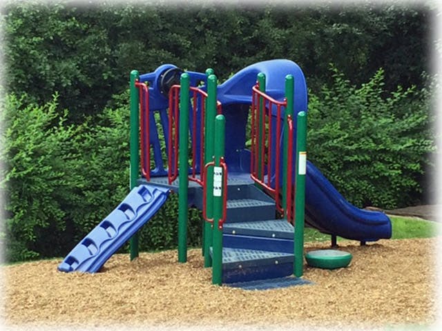 Playground structure with slides and stairs