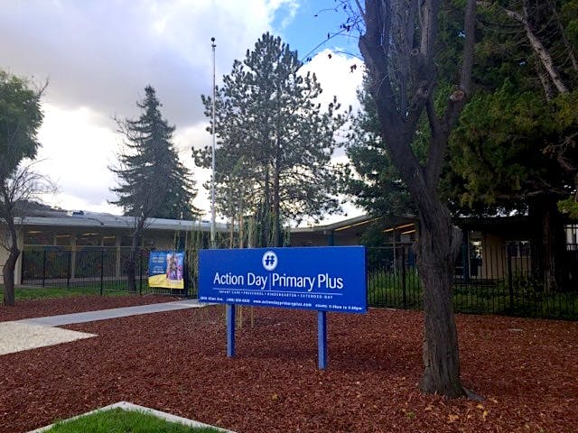 Blue sign for Action Day Primary Plus in front of a building