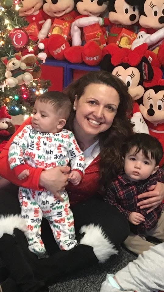 Person holding two children