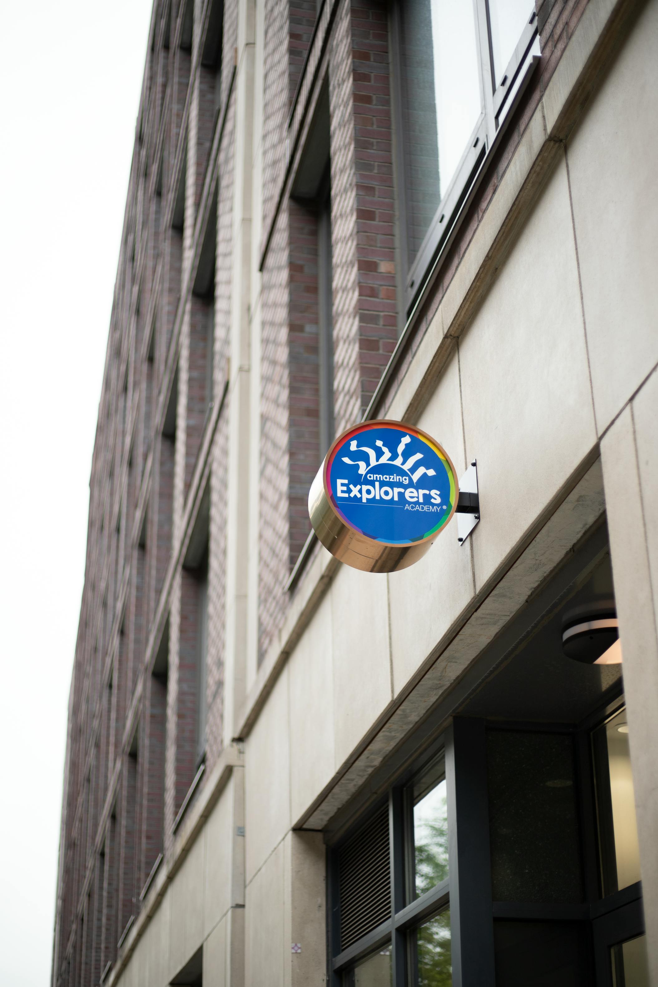 Round blue sign with "Explorers" text on a building facade