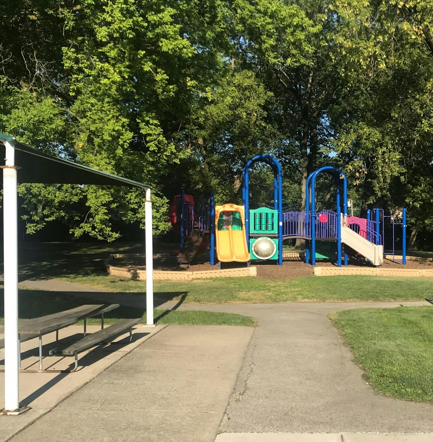 Colorful playground structure with slides and climbing areas in a park