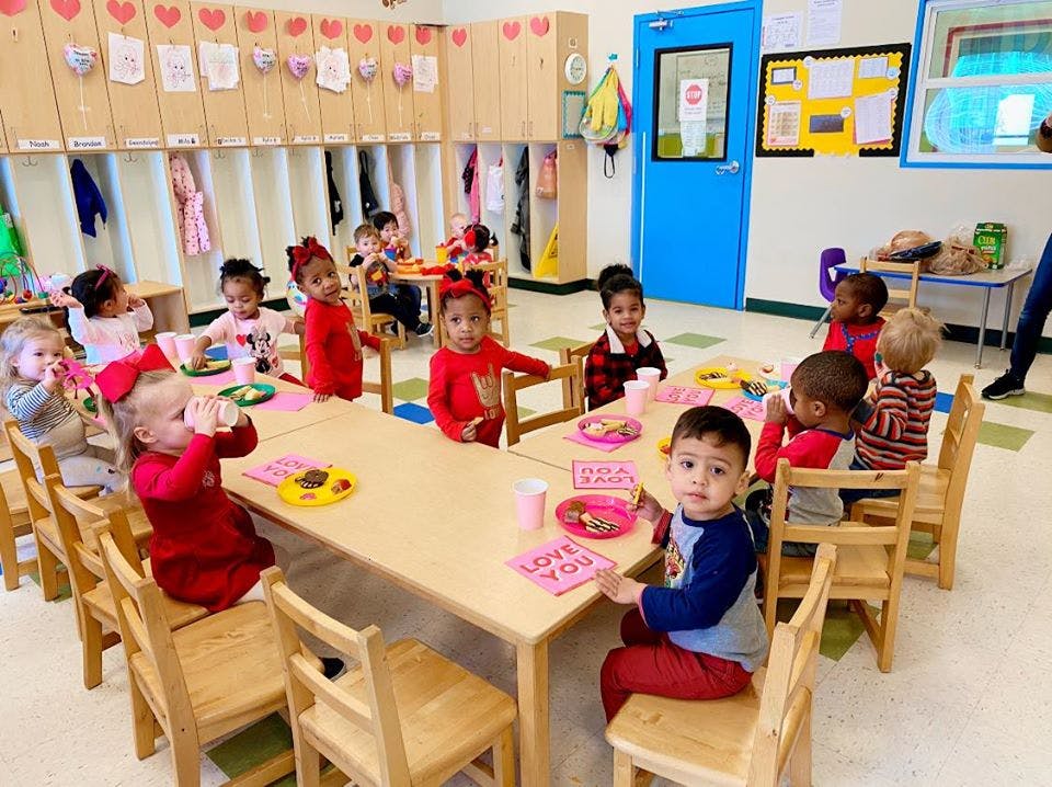 Children sitting at tables in a classroom