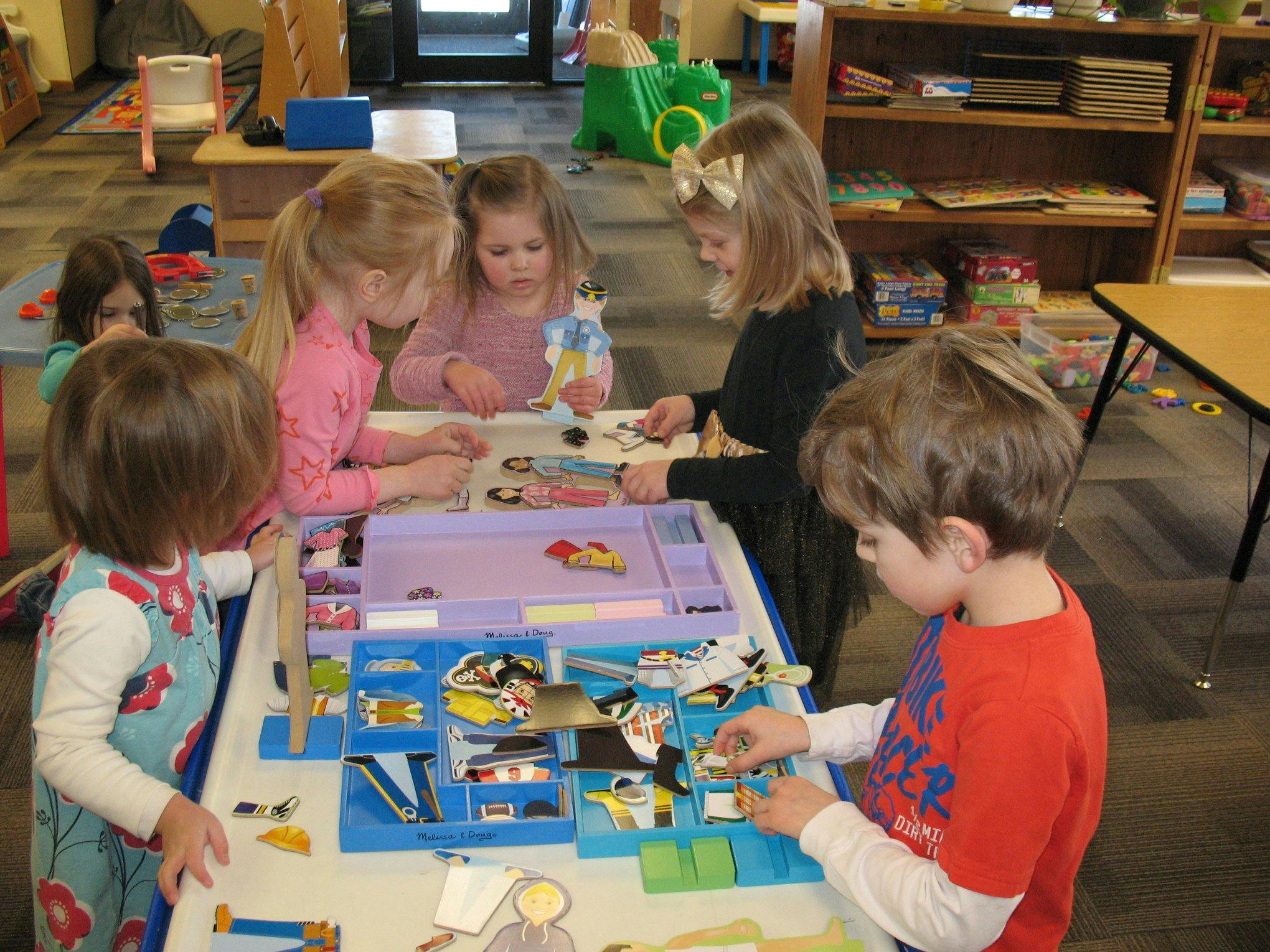 Children playing with toys at a table