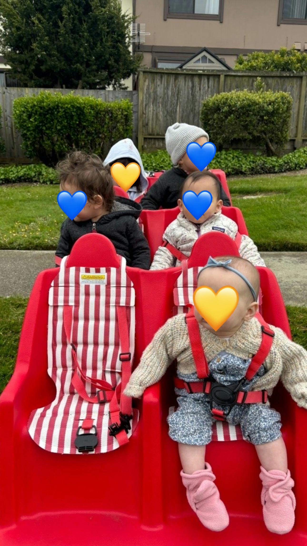 Multiple children in a red wagon