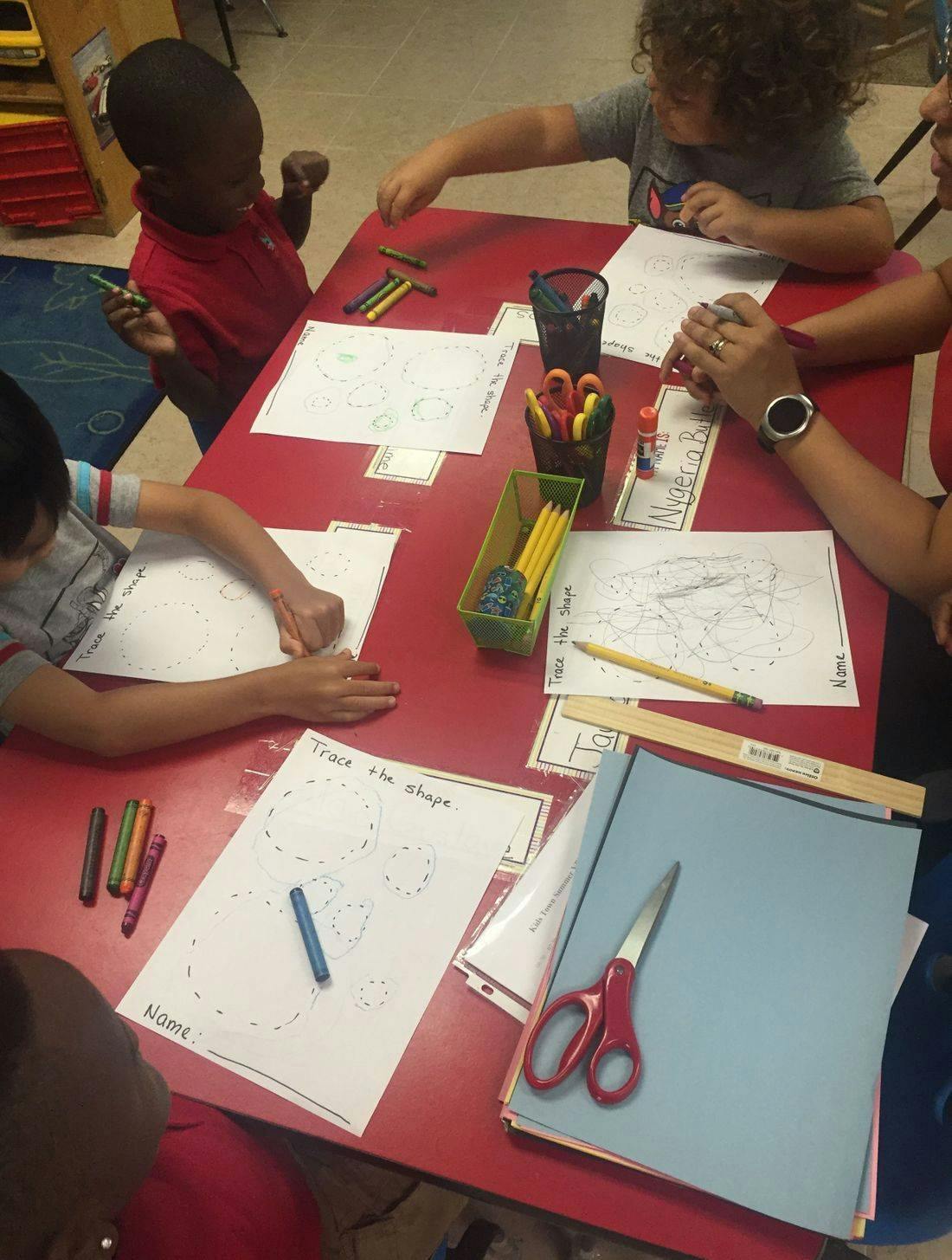 Children drawing and coloring at a table