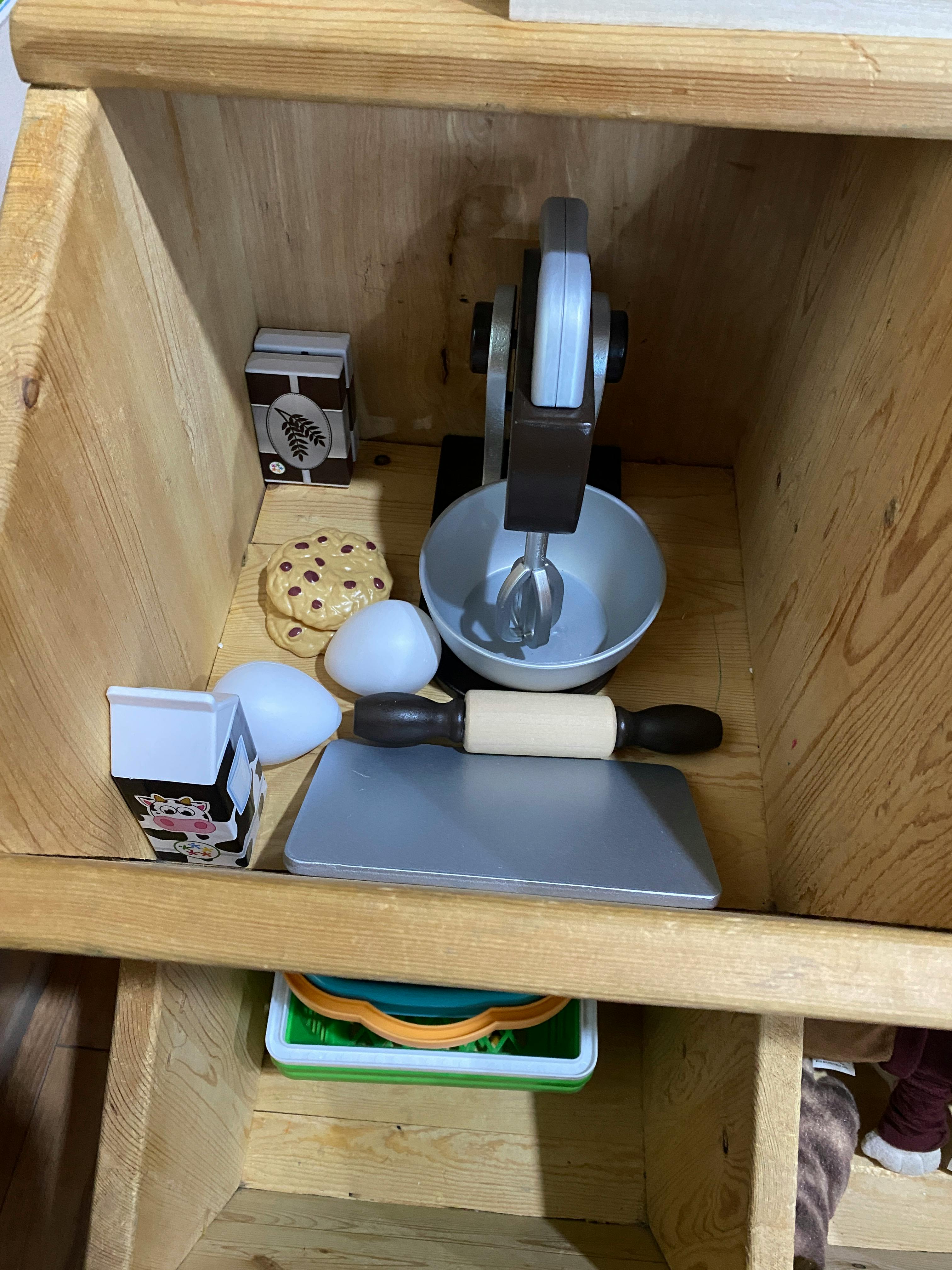 Toy kitchen accessories including a mixer, rolling pin, and milk carton