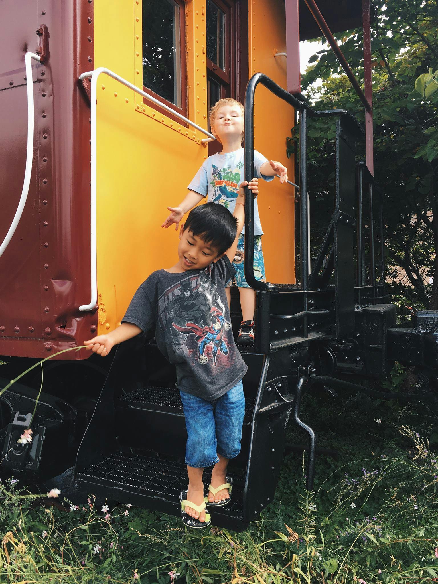 Two children on the steps of a train car