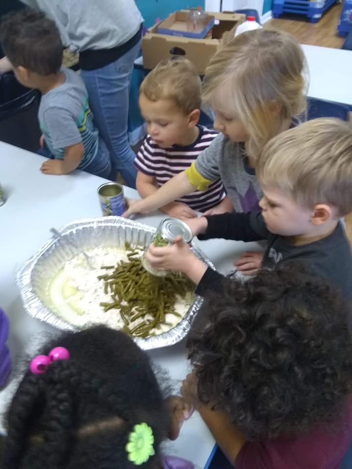 Children preparing food in a classroom