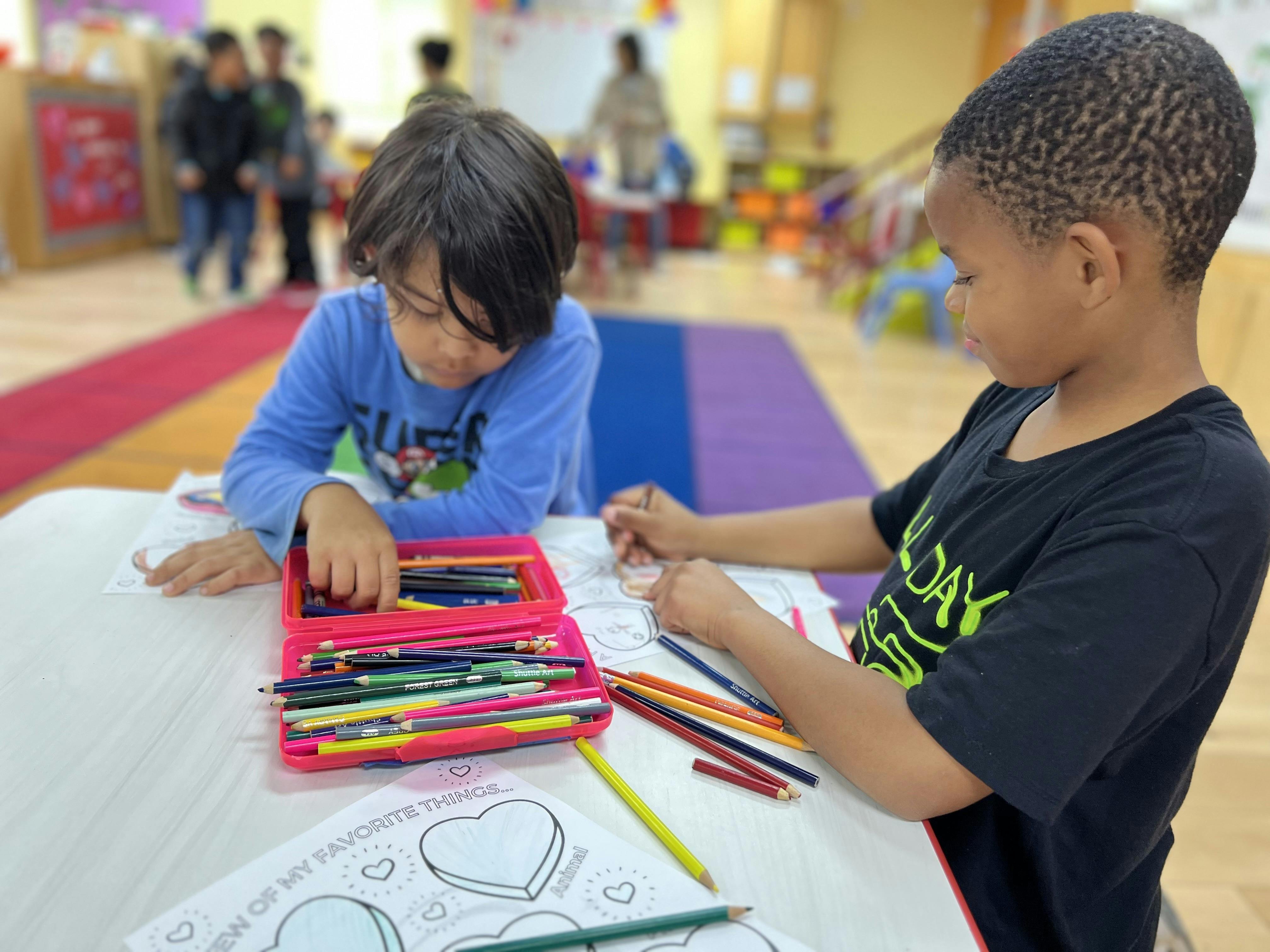 Two children coloring at a table