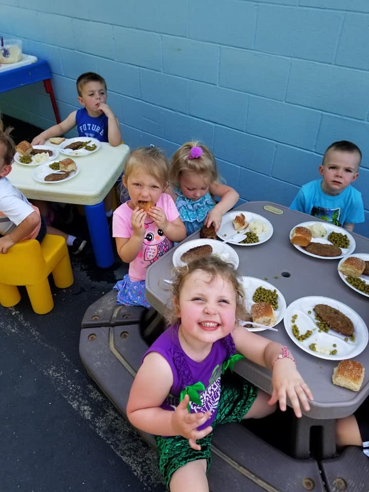 Children eating at picnic tables