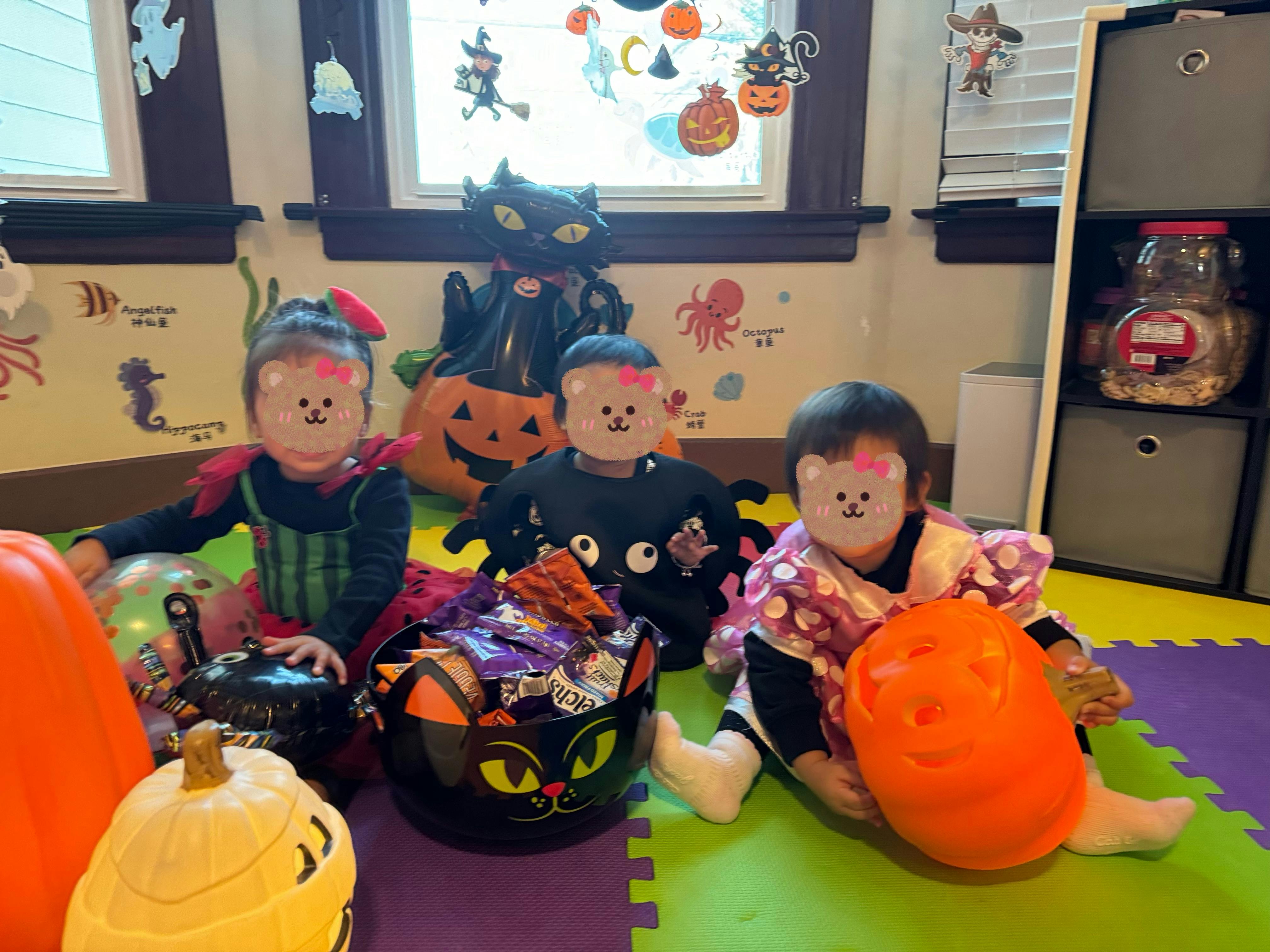 Three children in Halloween costumes with candy buckets