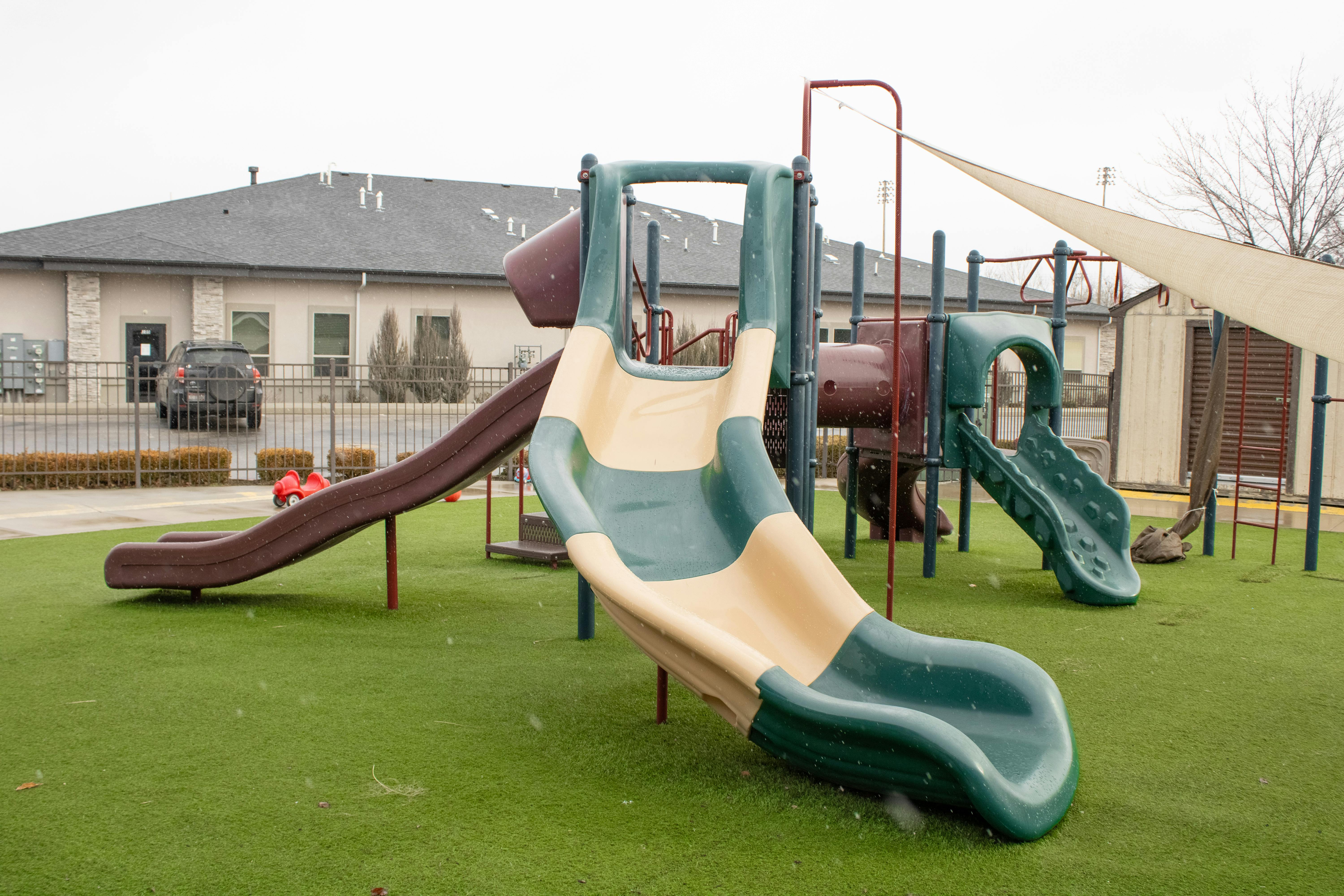 Playground with multiple slides on artificial turf