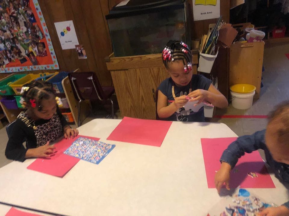 Three children doing crafts at a table