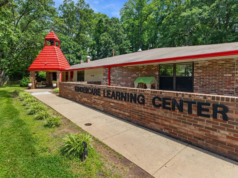 Brick Kindercare Learning Center building with red roof