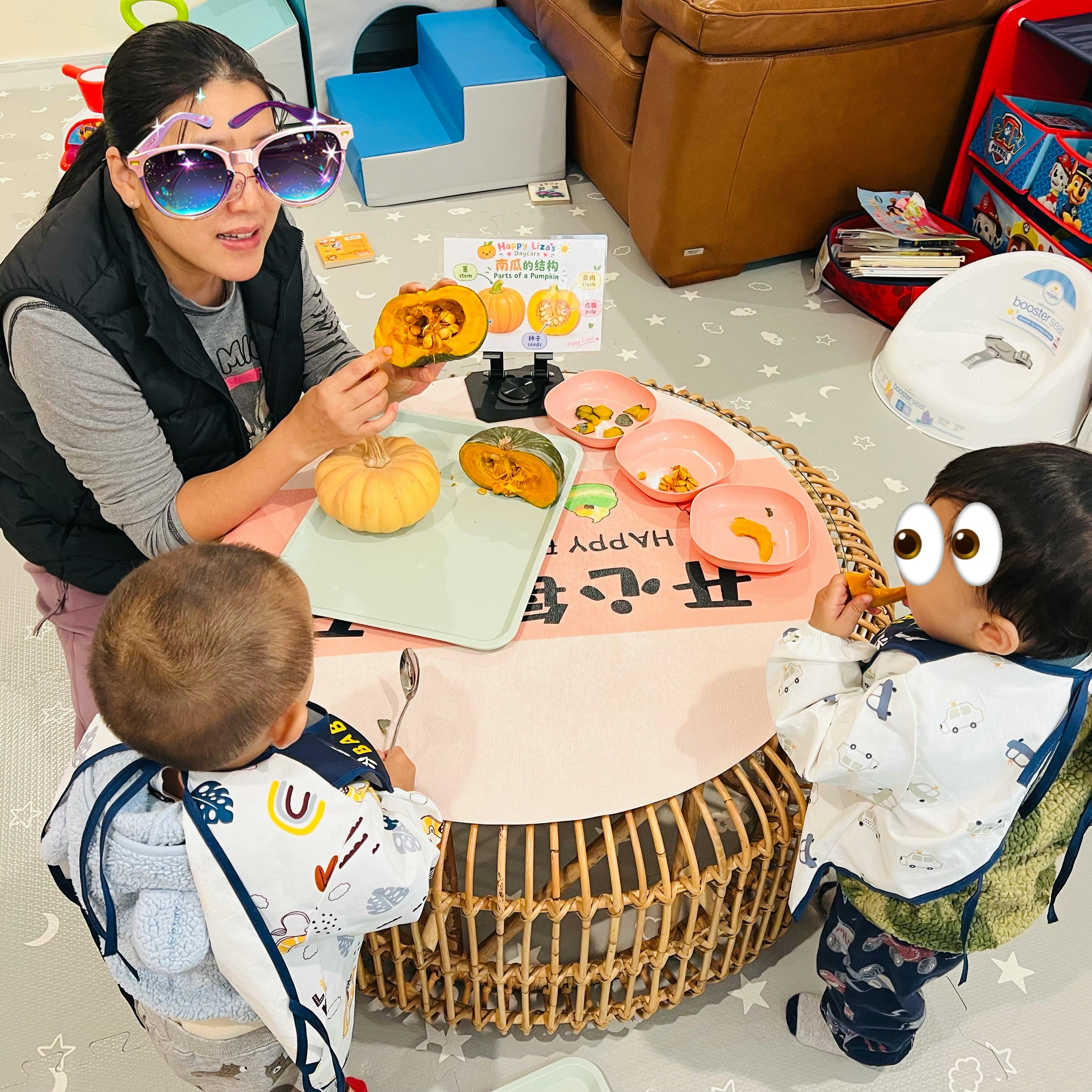 Adult and two children examining pumpkin parts during an educational activity