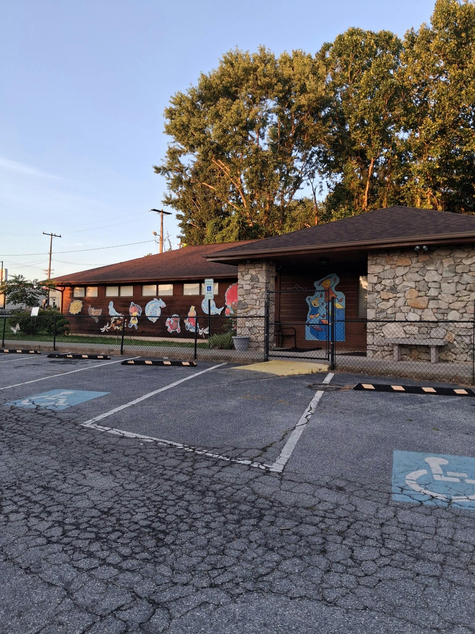 Building with mural and parking lot featuring accessible parking spaces