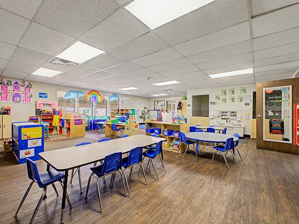 Empty classroom with small tables and chairs