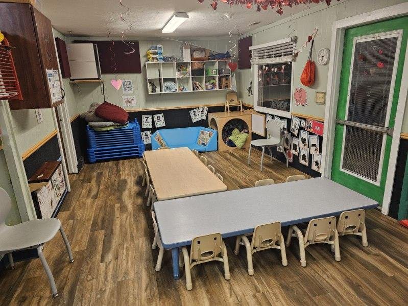 Empty classroom with small tables and chairs