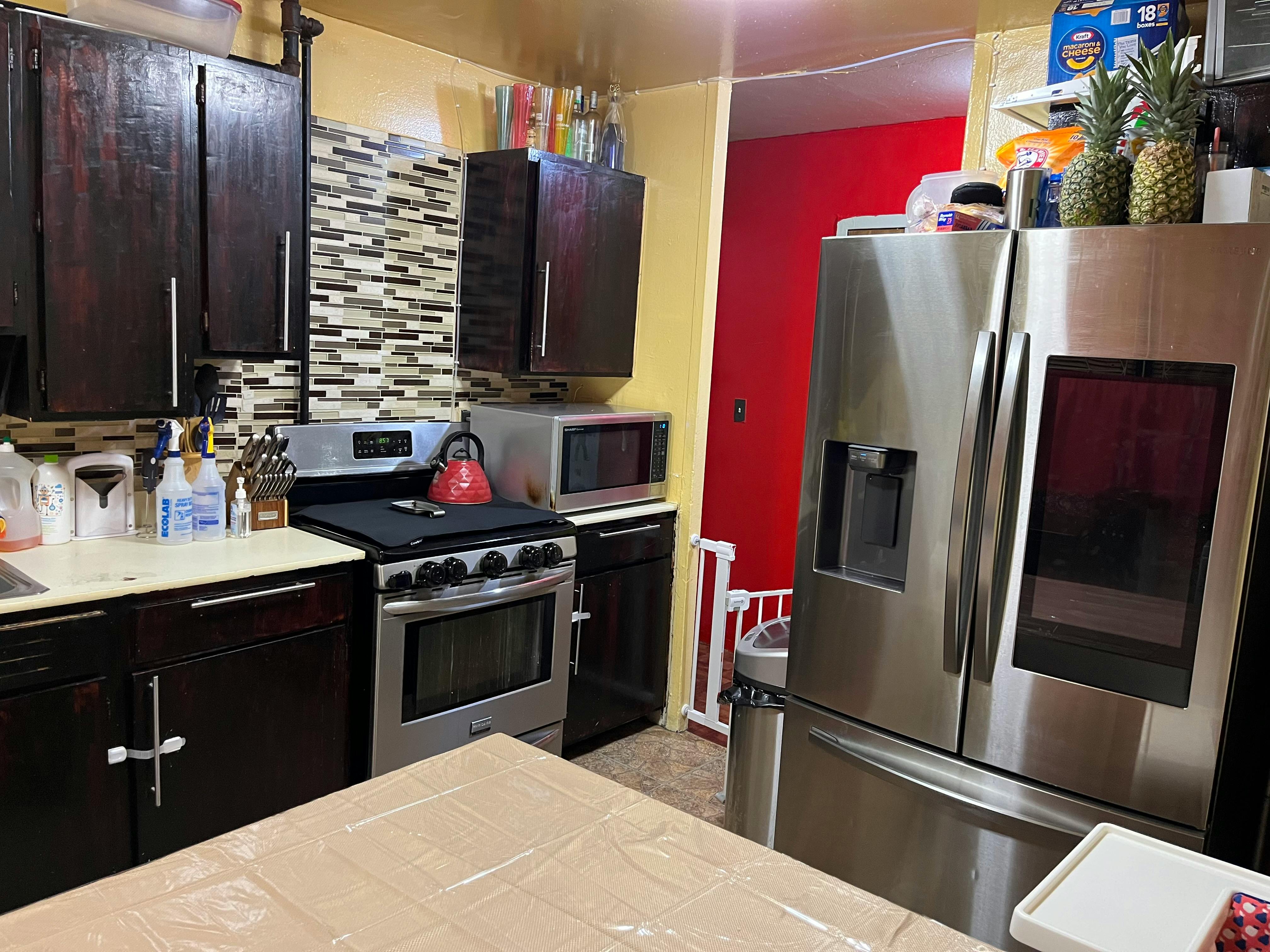 Kitchen with stainless steel appliances and dark wood cabinets