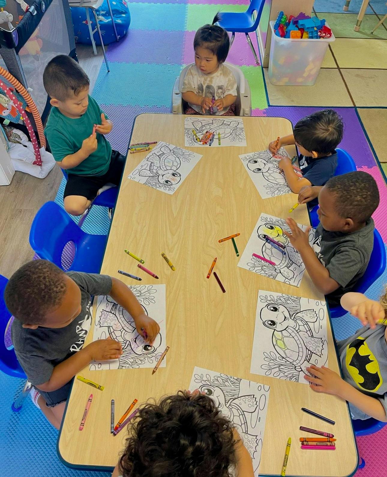 Children coloring at a table