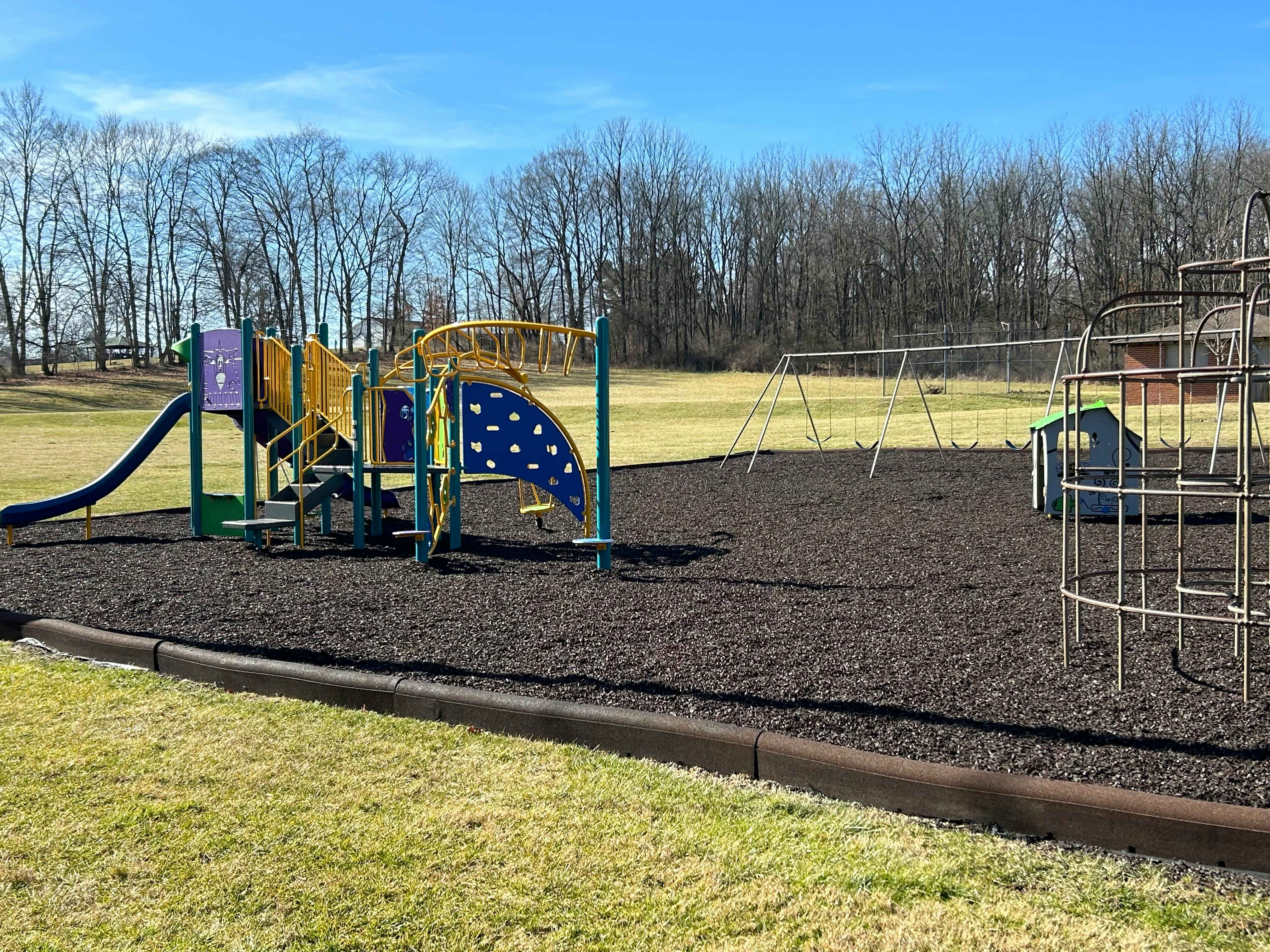Playground with slides, swings, and climbing structures