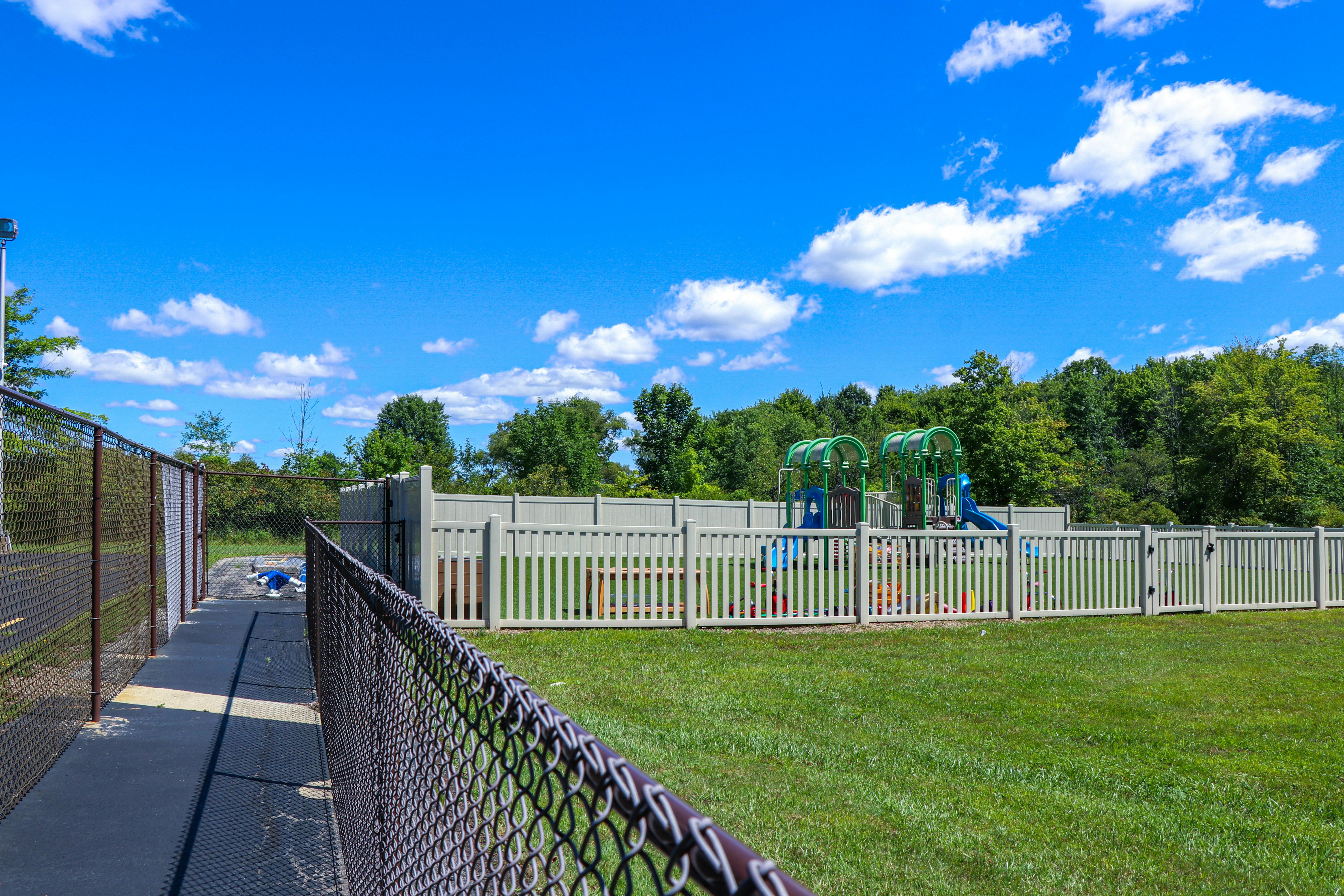 Playground with fences and green grass