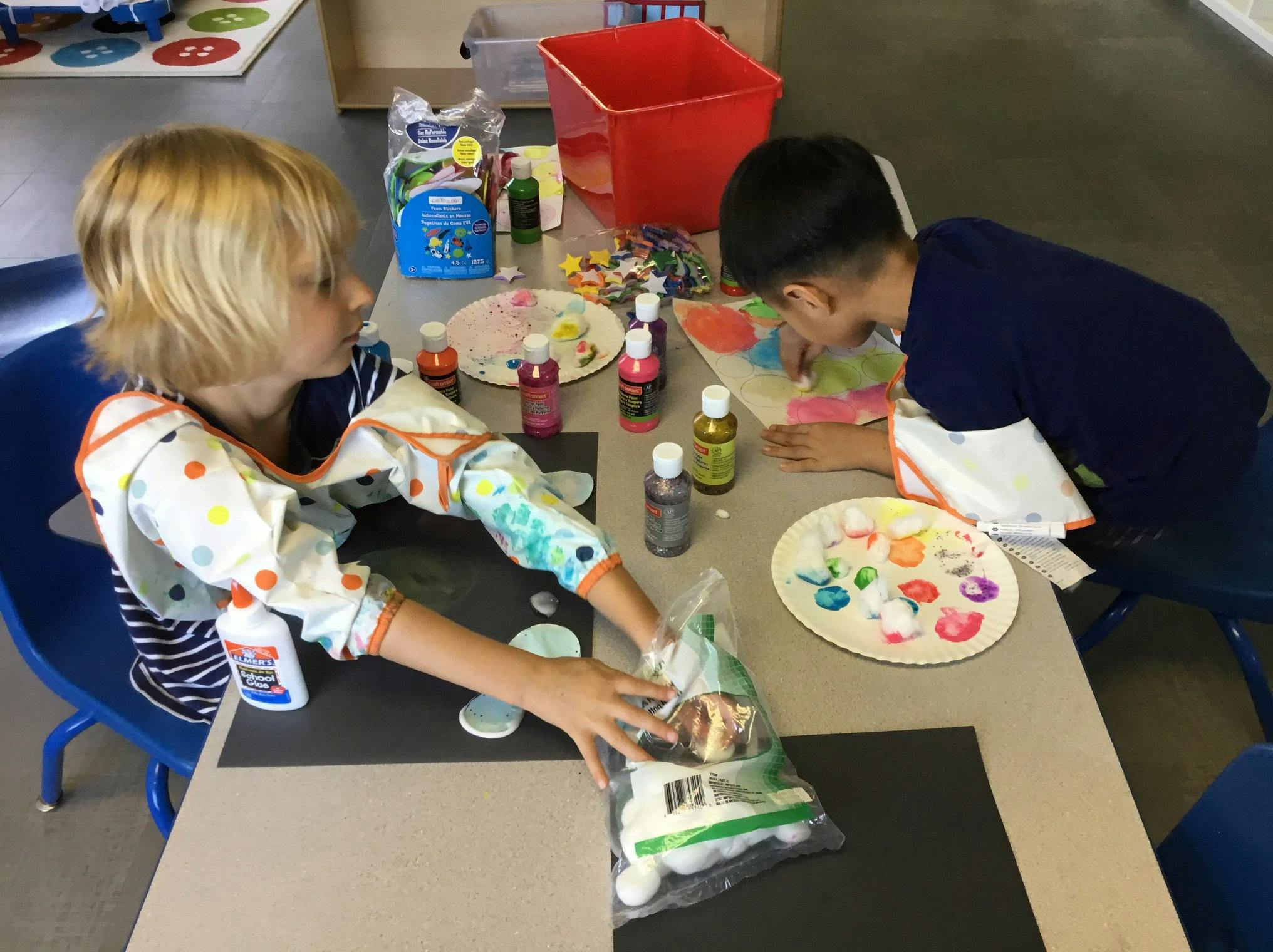 Two children doing an art project at a table