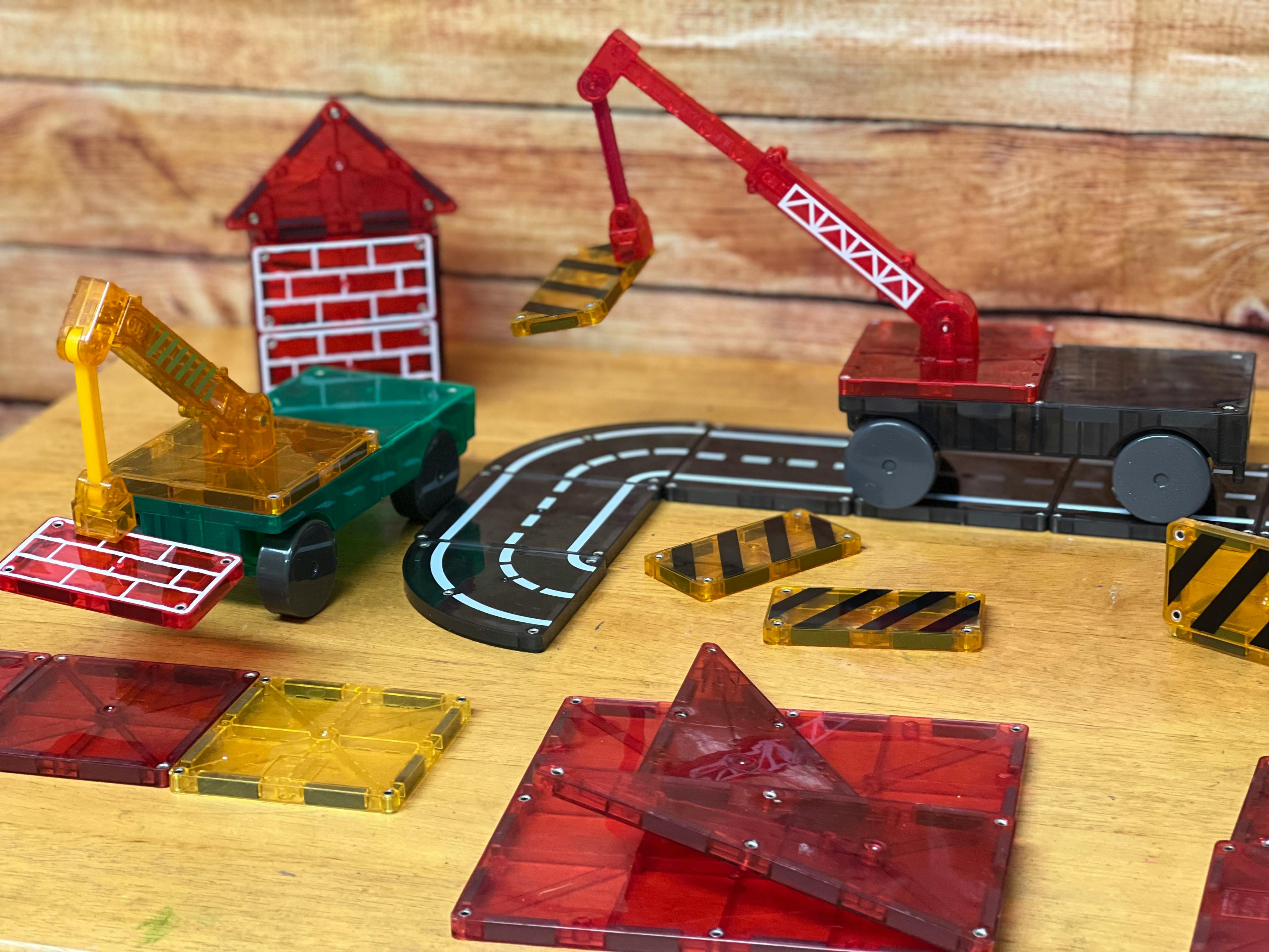 Magnetic tile construction toys including cranes, road pieces, and building parts