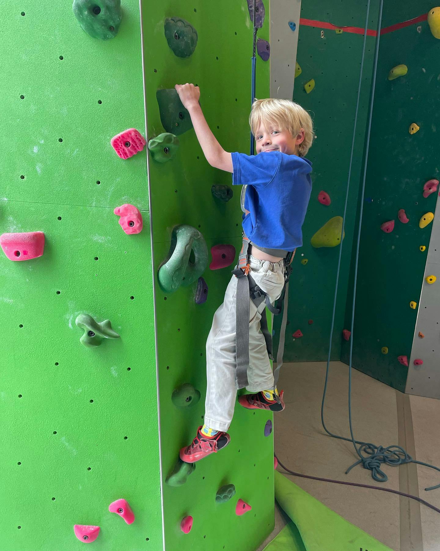 Child climbing an indoor rock wall