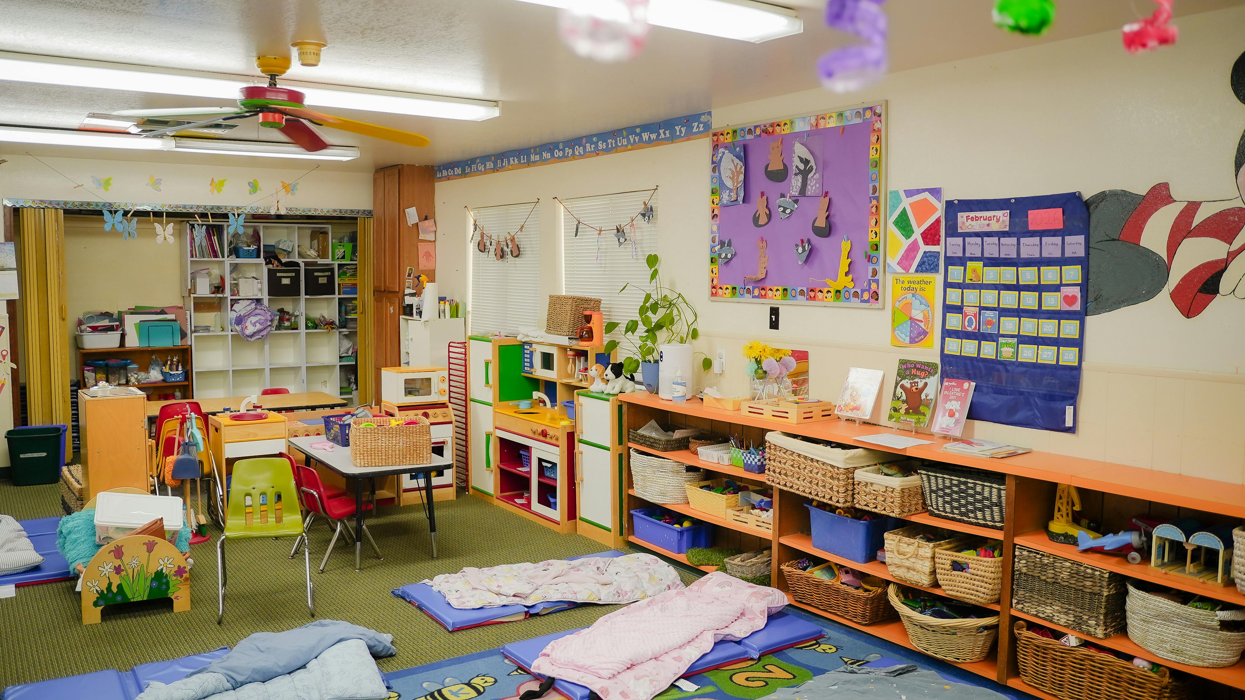Classroom interior with play stations and mats on the floor
