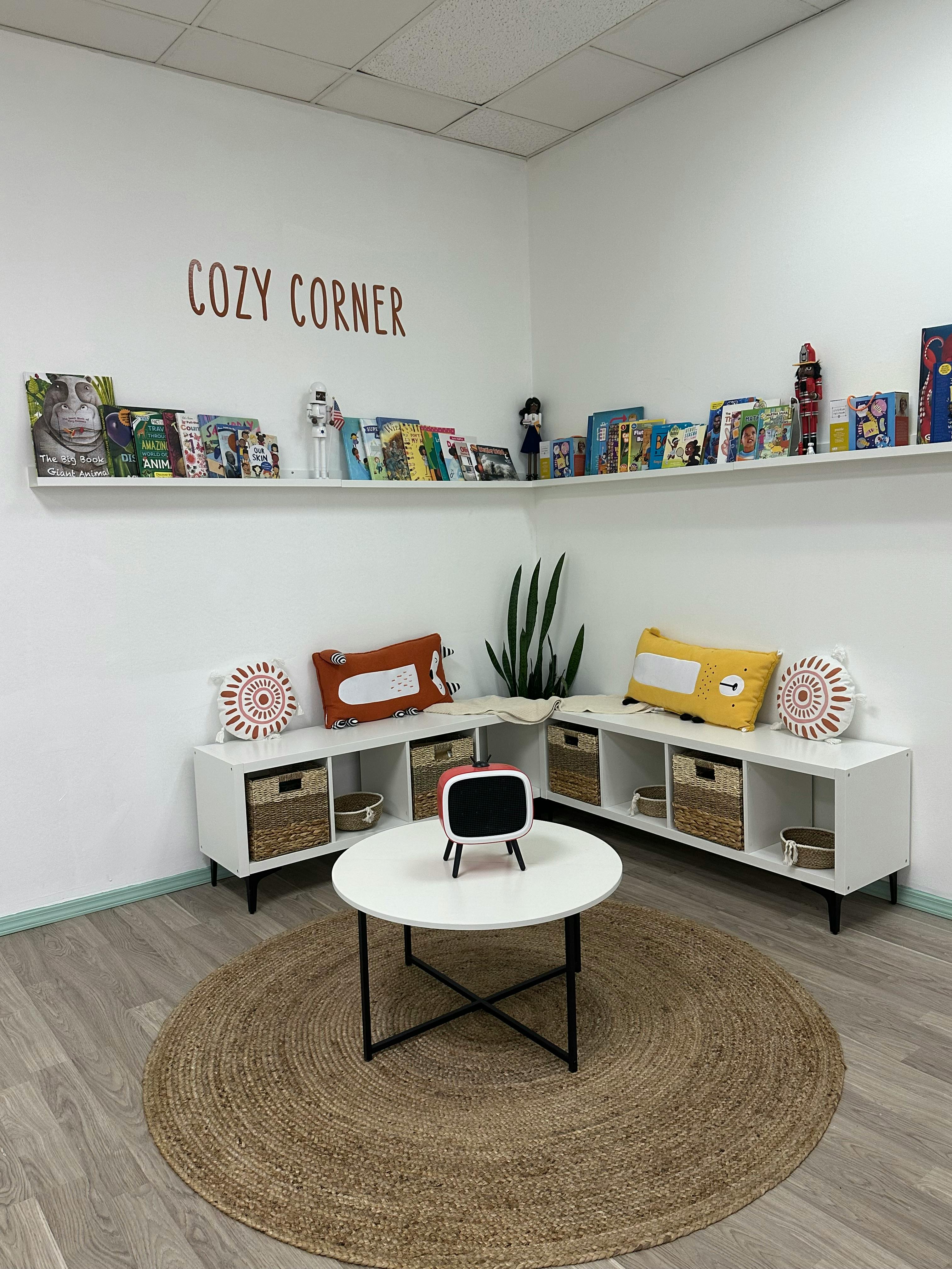 Cozy corner with shelves of books, storage cubes, and a round rug