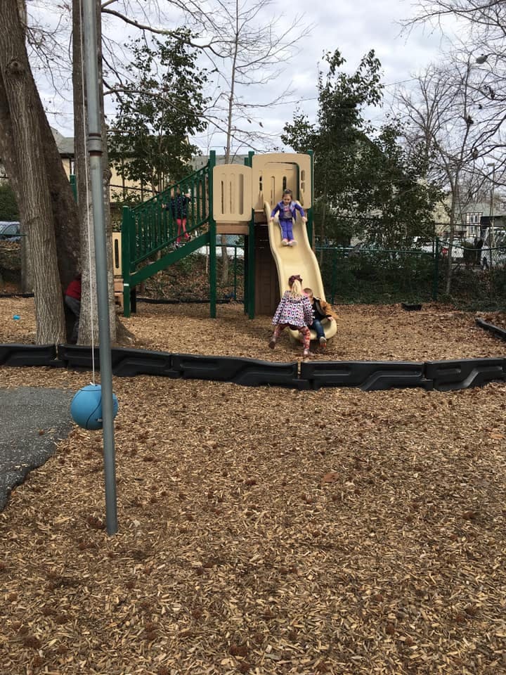 Children playing on a playground slide