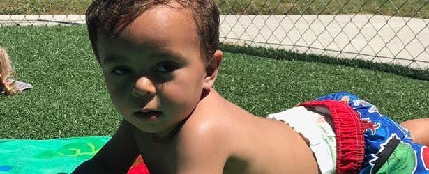 Child lying on stomach on grass