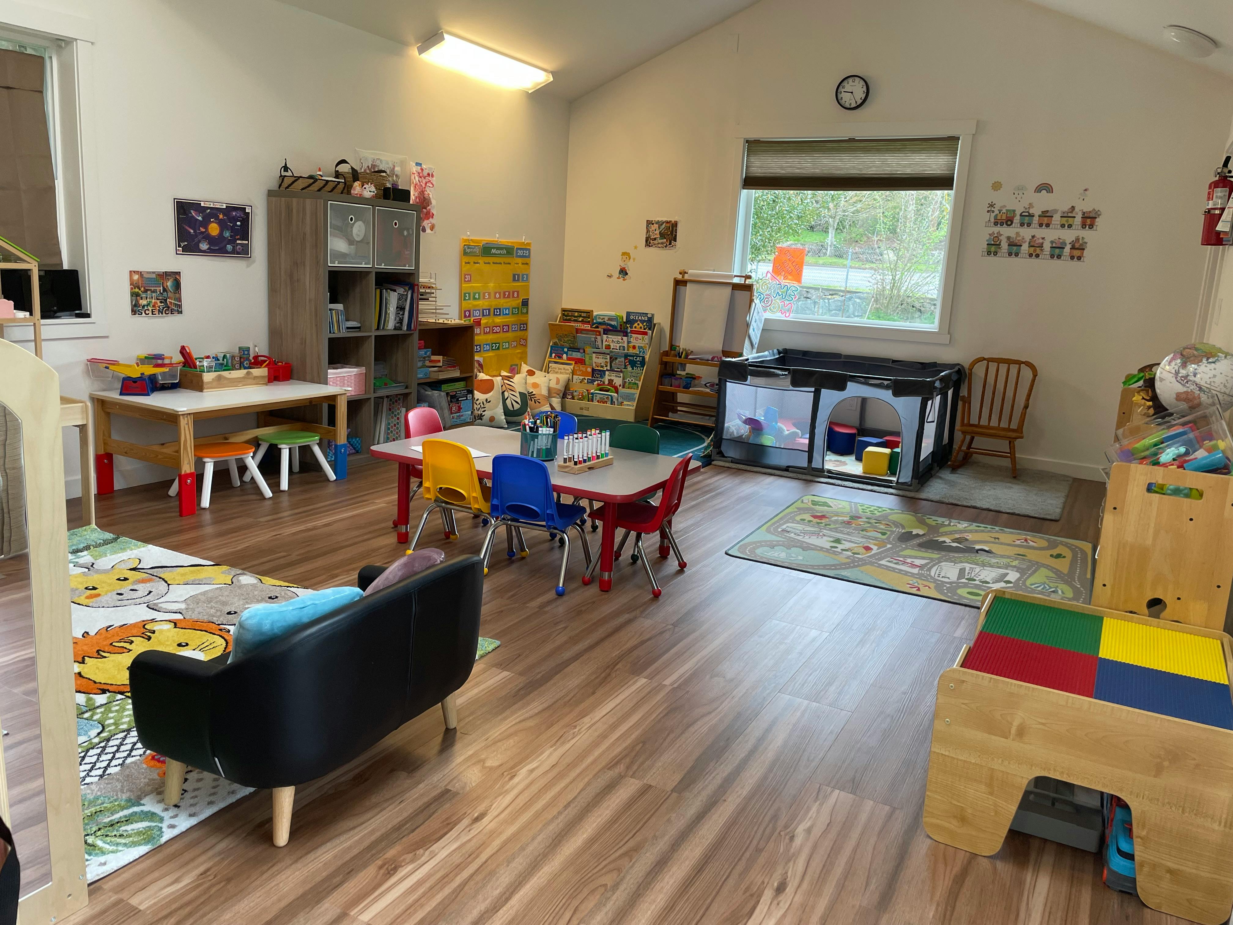 Playroom with small tables, chairs, and toys