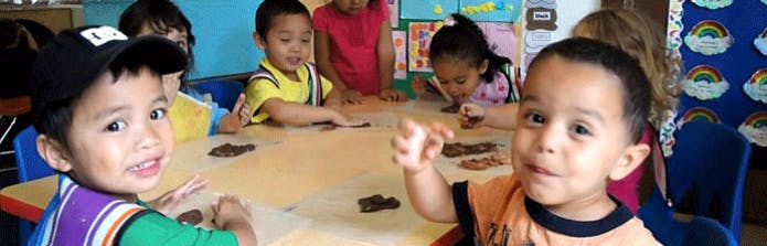 Children sitting at a table in a classroom