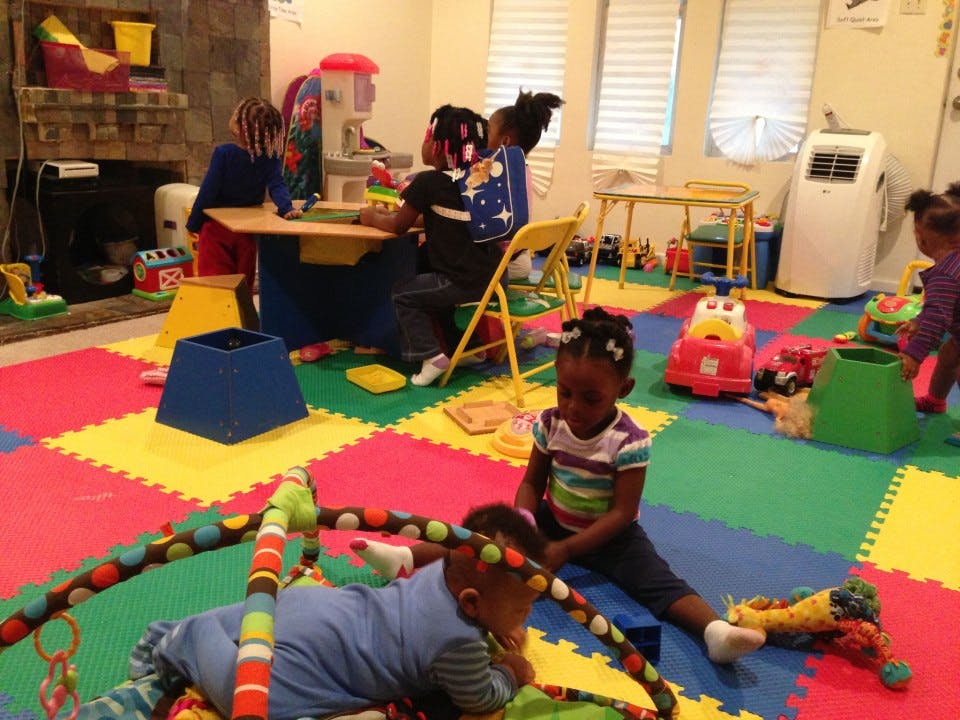 Children playing in a room with colorful floor mats