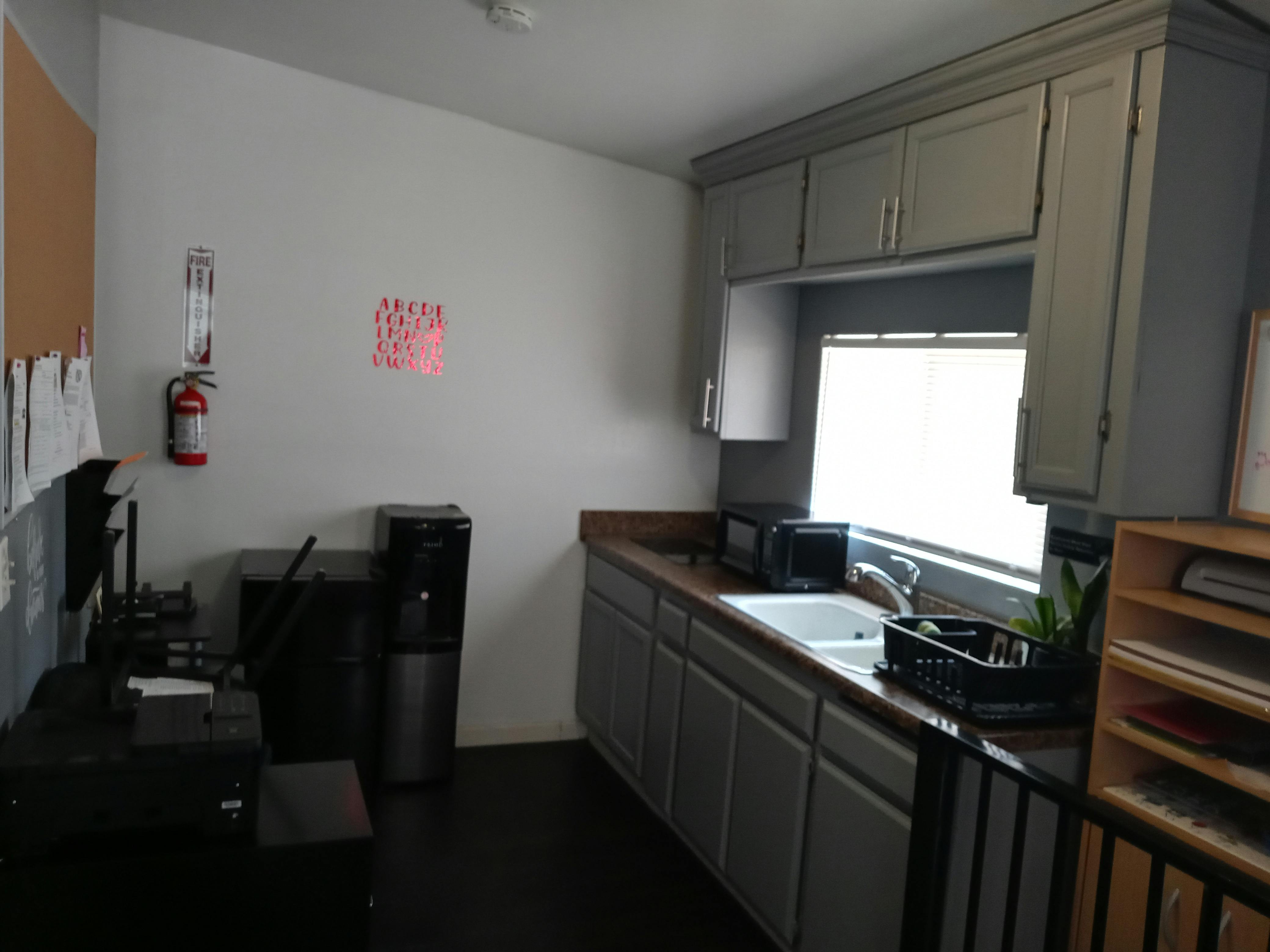 Kitchenette with sink, cabinets, and counter space