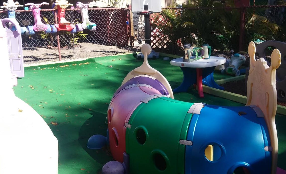 Playground with colorful plastic climbing structure and small table