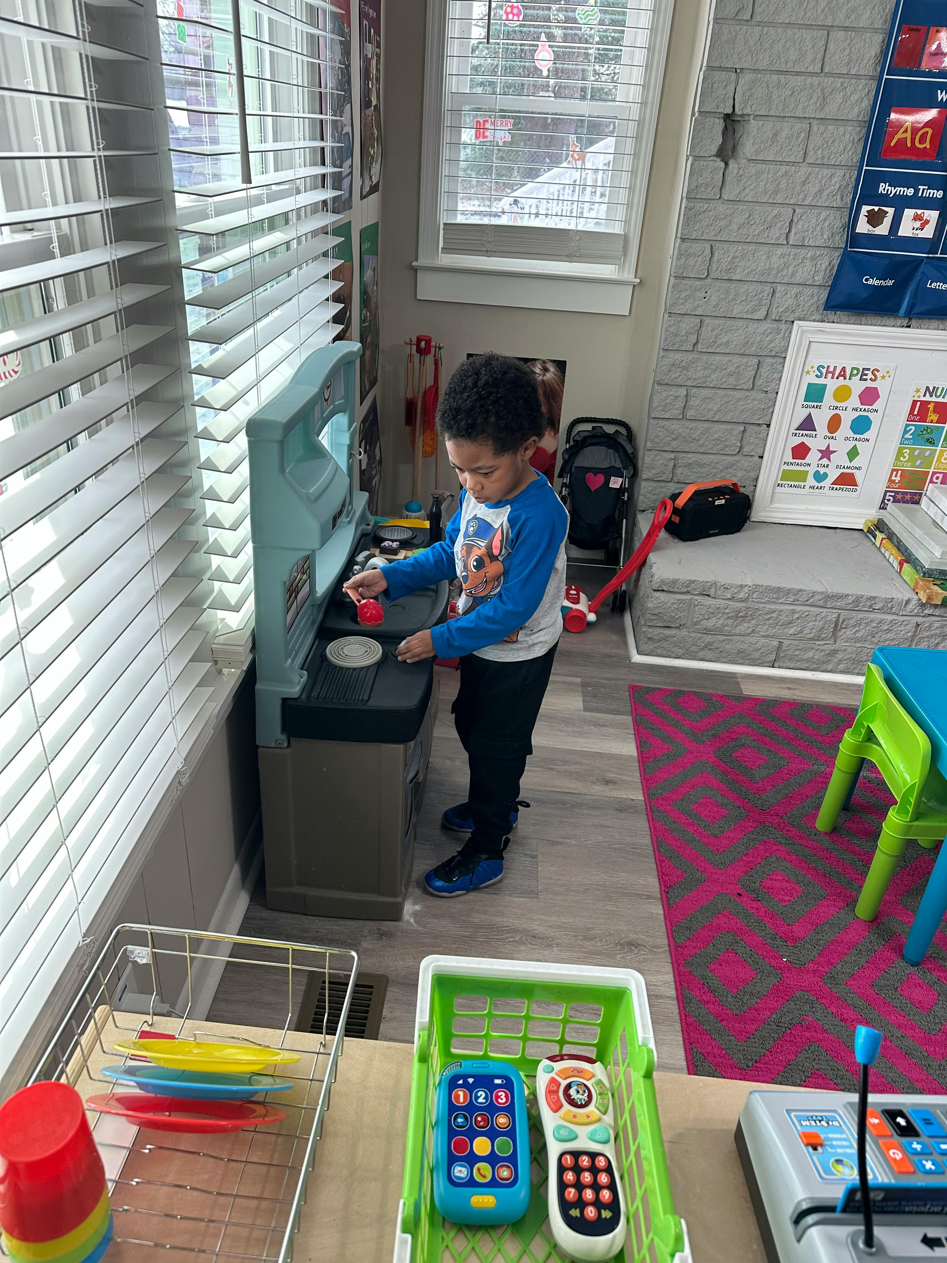 Child playing with a toy kitchen set