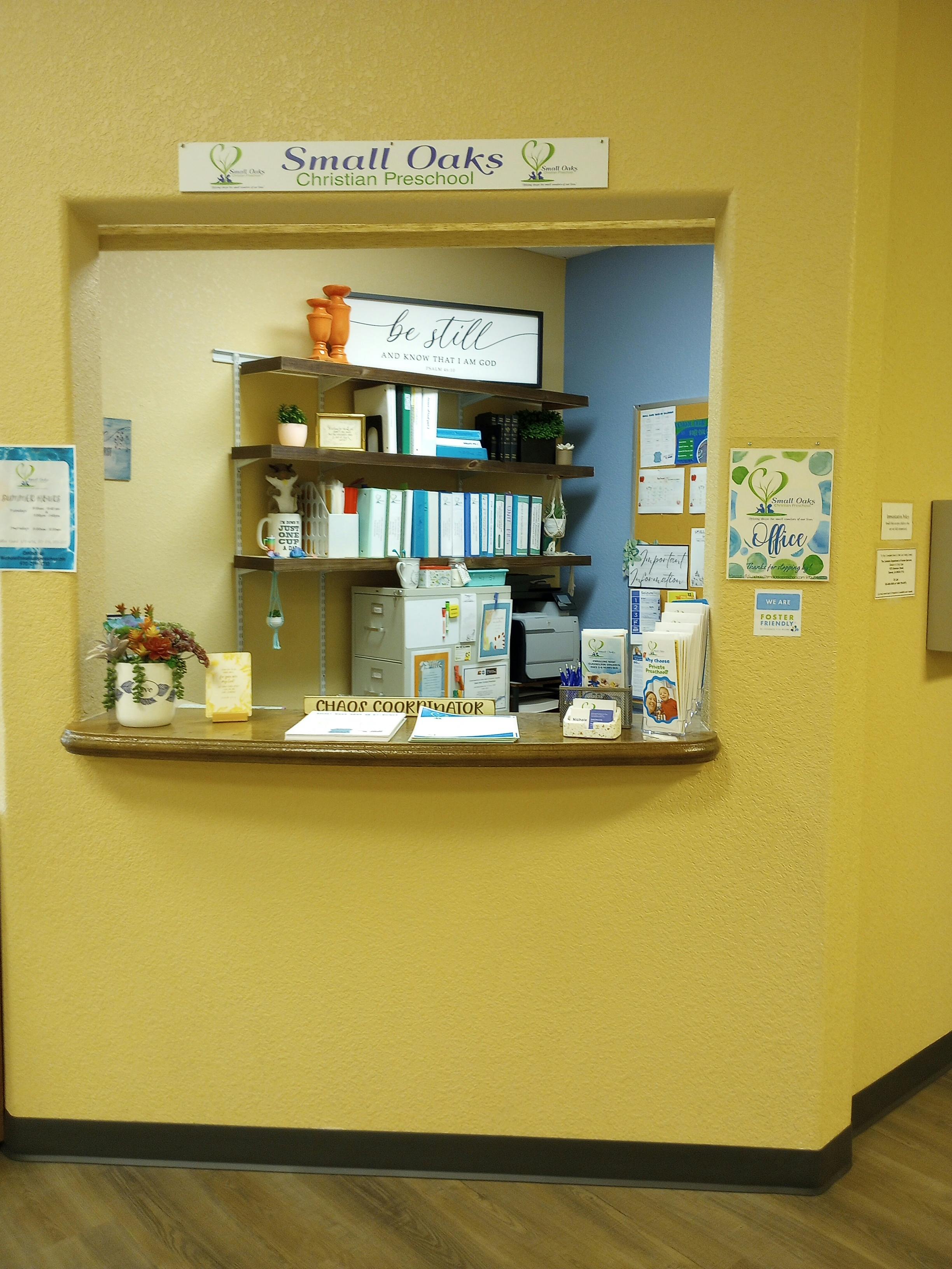Reception desk with a sign that reads "Small Oaks Christian Preschool"