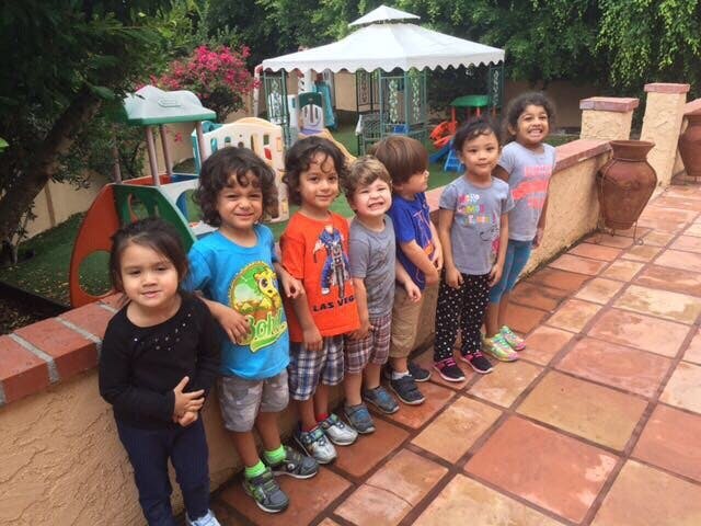 Group of children standing in a line outdoors