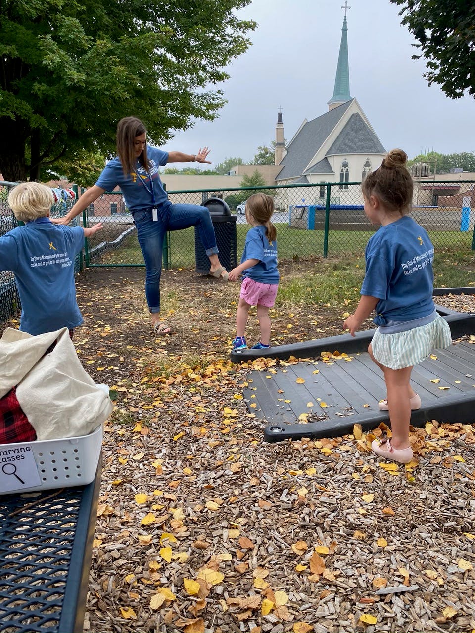Adult and two children playing outdoors