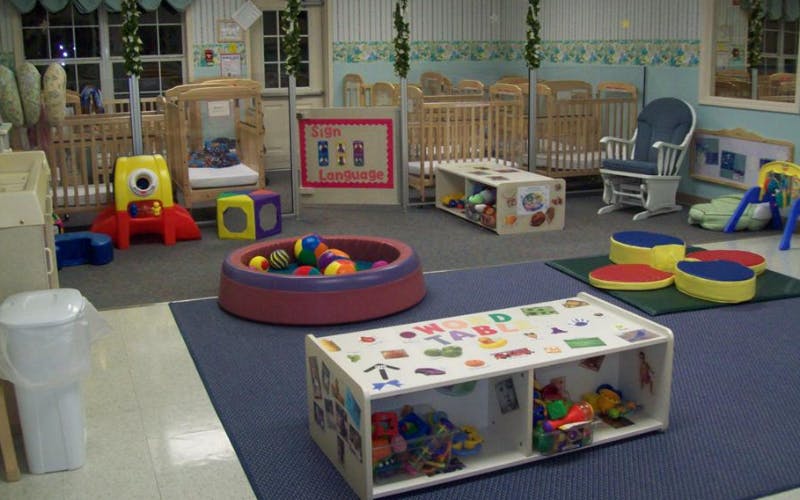 Cribs and play items in a nursery or daycare room