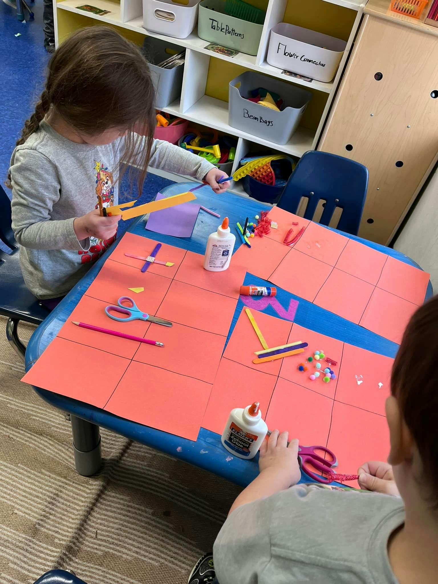 Two children doing crafts at a table