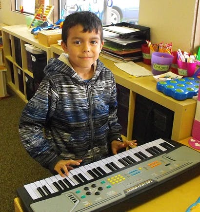 Child playing a keyboard instrument