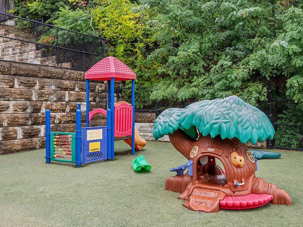 Playground with plastic slide, playhouse, and abacus activity