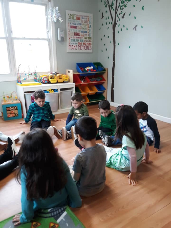 Children sitting on the floor in a classroom