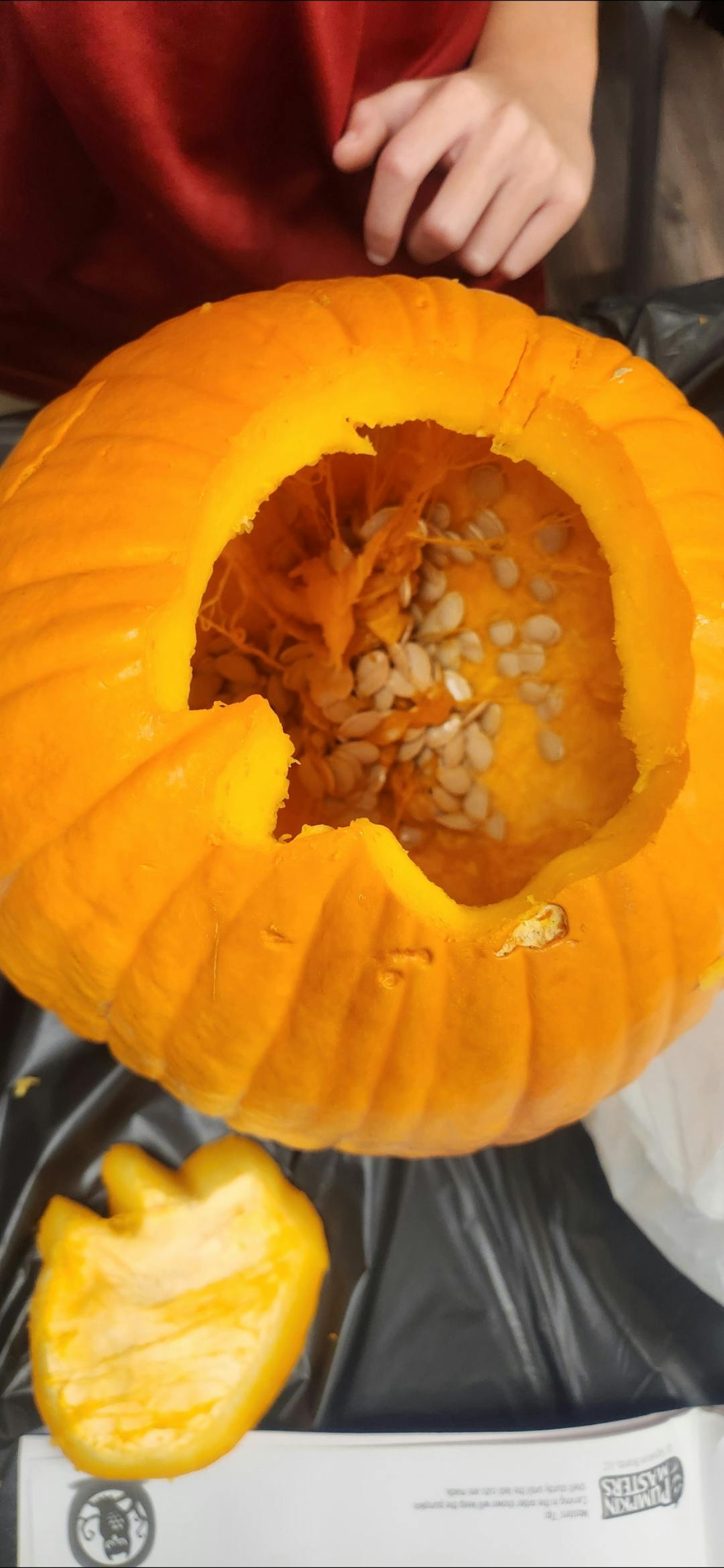 Top-down view of a carved pumpkin with seeds and pulp inside