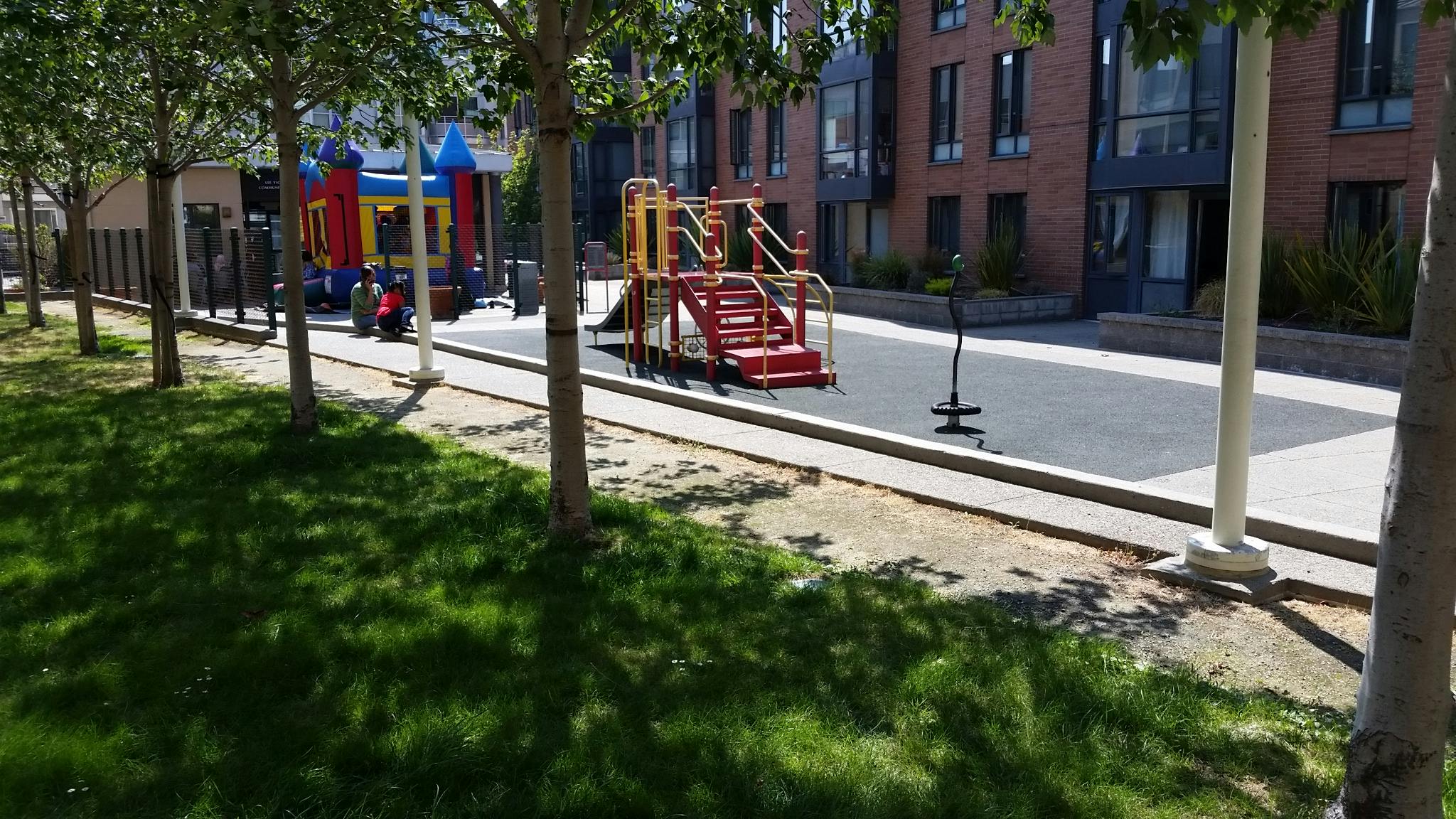 Playground with colorful play structures and green grass
